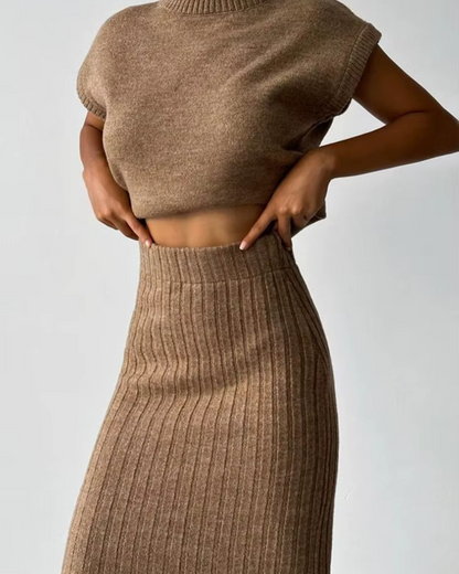 Conjunto de blusa sem mangas e saia comprida, exclusivo para mulher. 