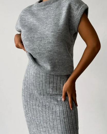 Conjunto de blusa sem mangas e saia comprida, exclusivo para mulher. 